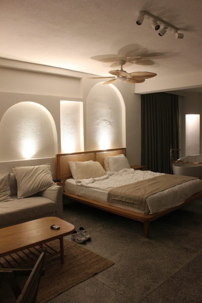Daily relaxation space with cozy bed, soft lights, and calming minimalist decor.