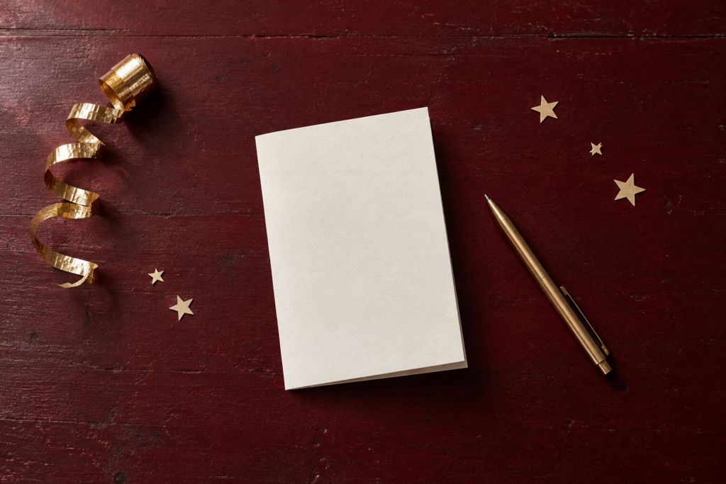 Folded blank paper and a pen with subtle gold stars for a New Year's Eve reflection